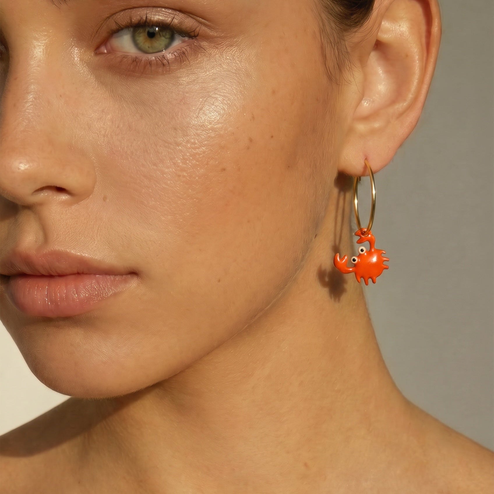 Women's orange enamel crab earrings with 18kt yellow vermeil