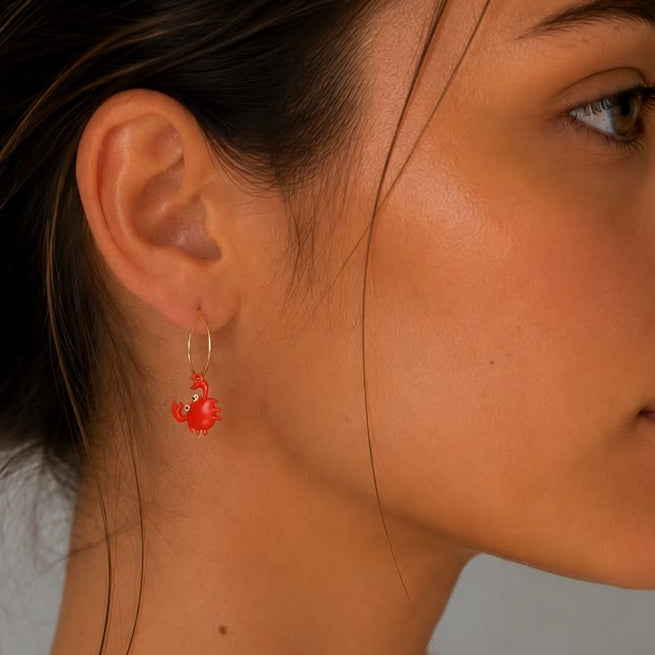 Women's orange enamel crab earrings with 18kt yellow vermeil